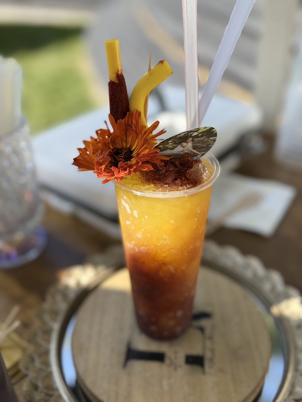 Layered mangonada with marigolds, tamarind candy, and a custom photo topper