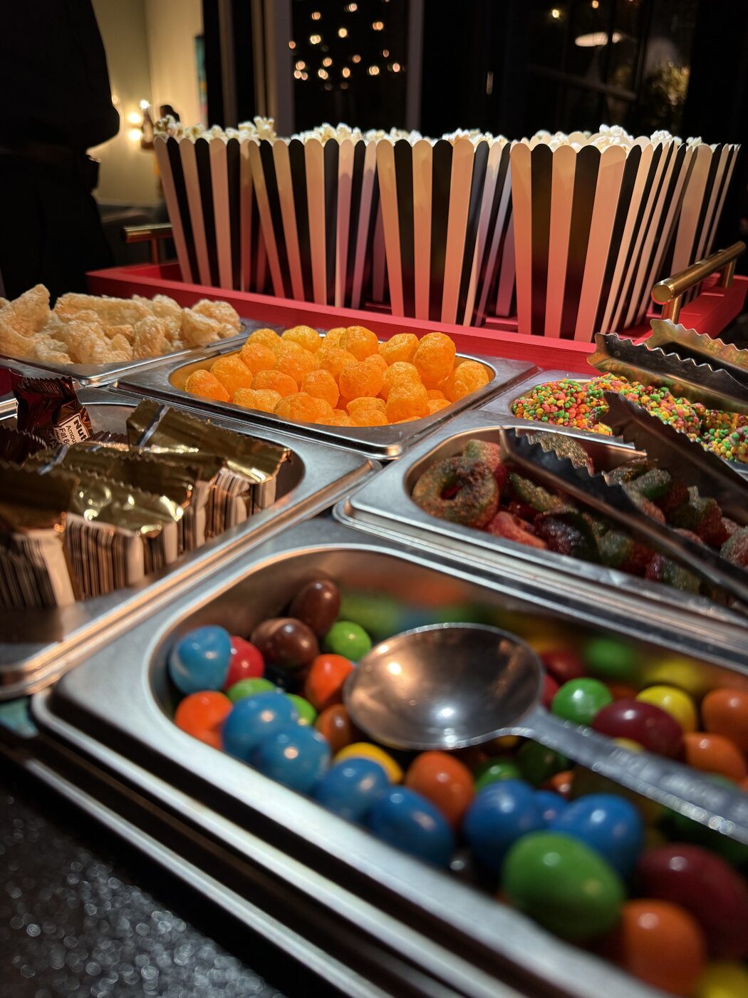 Late-night snack spread with popcorn, candies, and chips
