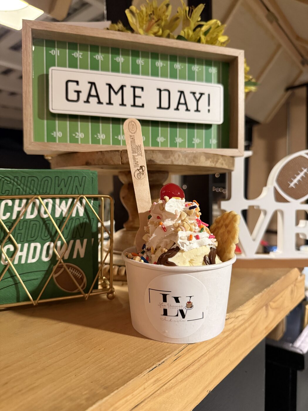 Ice cream sundae with an engraved wooden spoon at a game day birthday